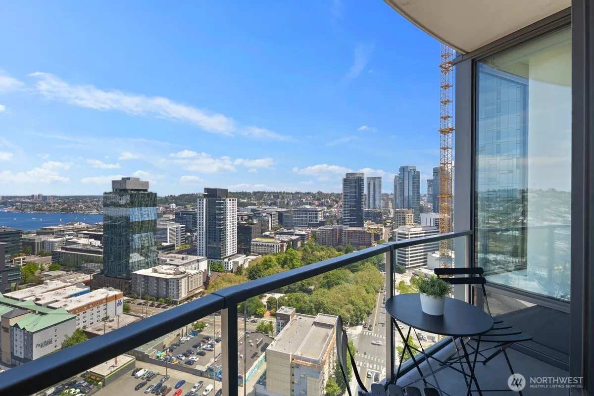 View of downtown Seattle skyline and Puget Sound from a highrise balcony, a real listing photo of a Wesley Gardner condo listing